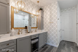 a bathroom with a double vanity sink and mirror