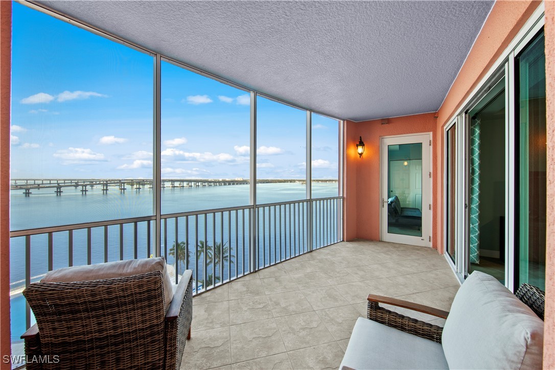 a balcony with furniture and a potted plant