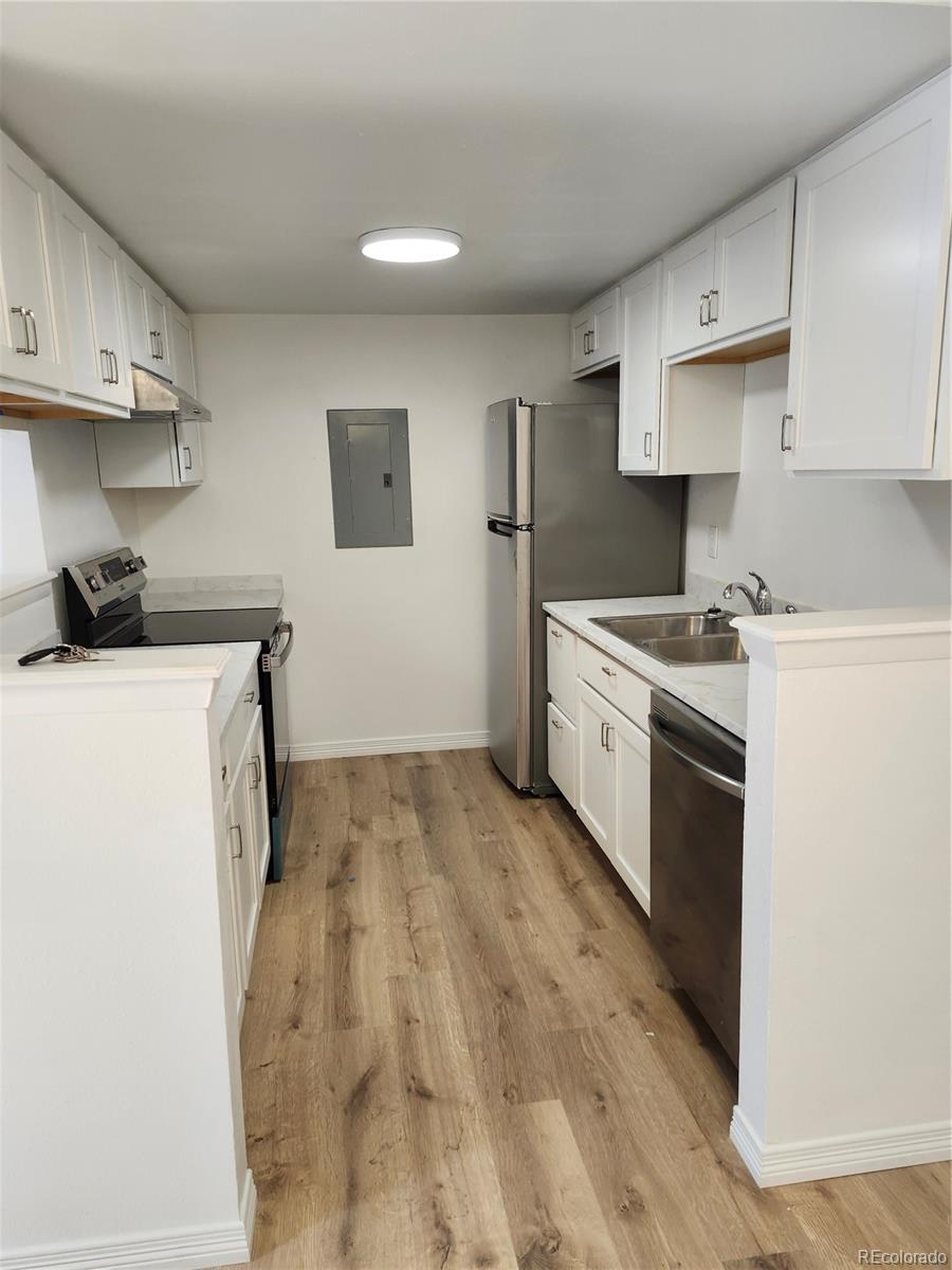 a kitchen with a stove a sink and a refrigerator