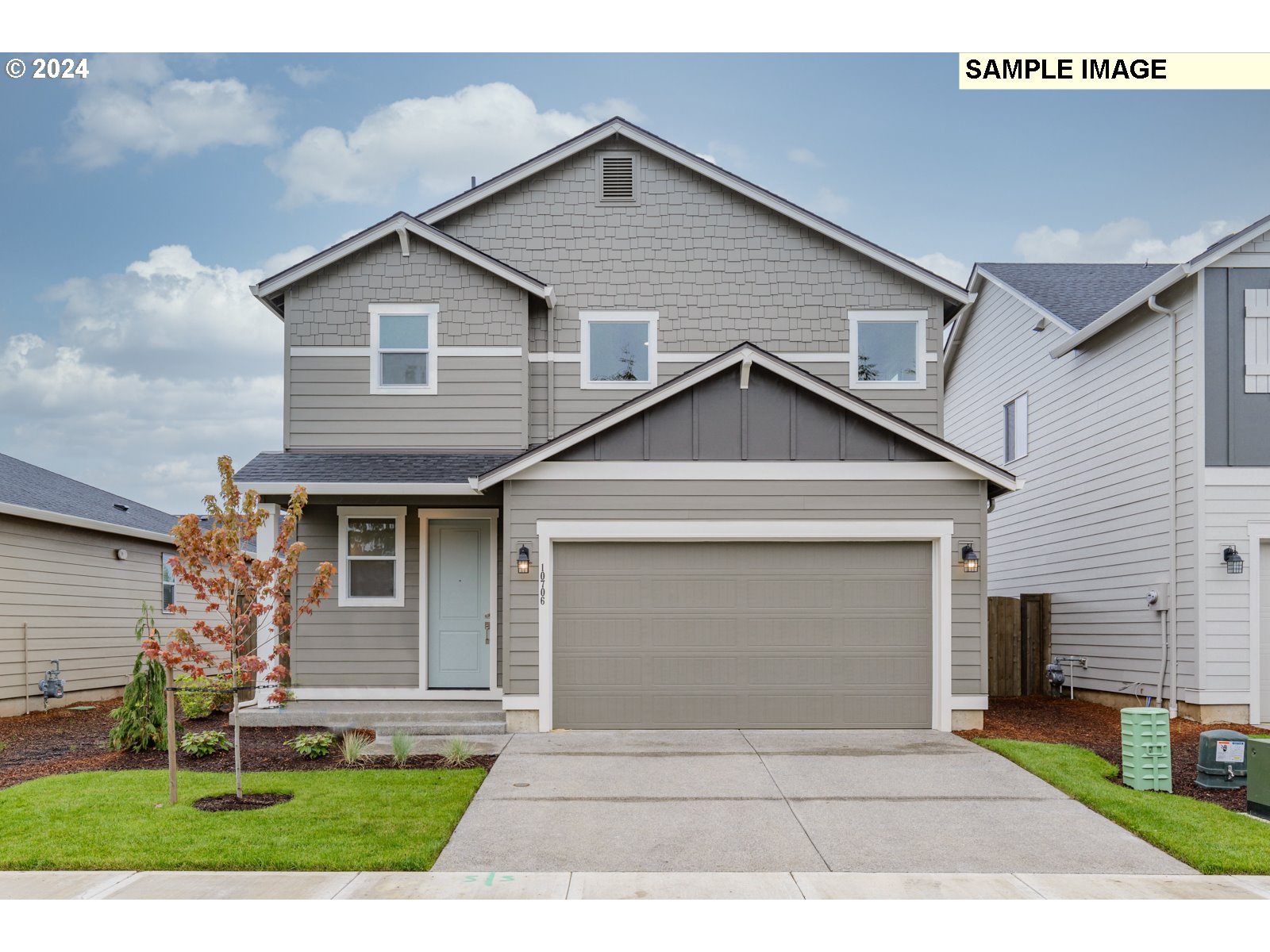 a front view of a house with a yard and garage