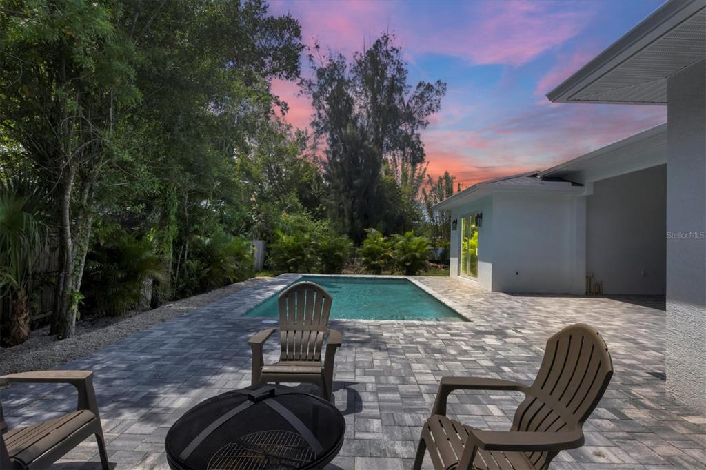 a view of backyard with outdoor seating and green space