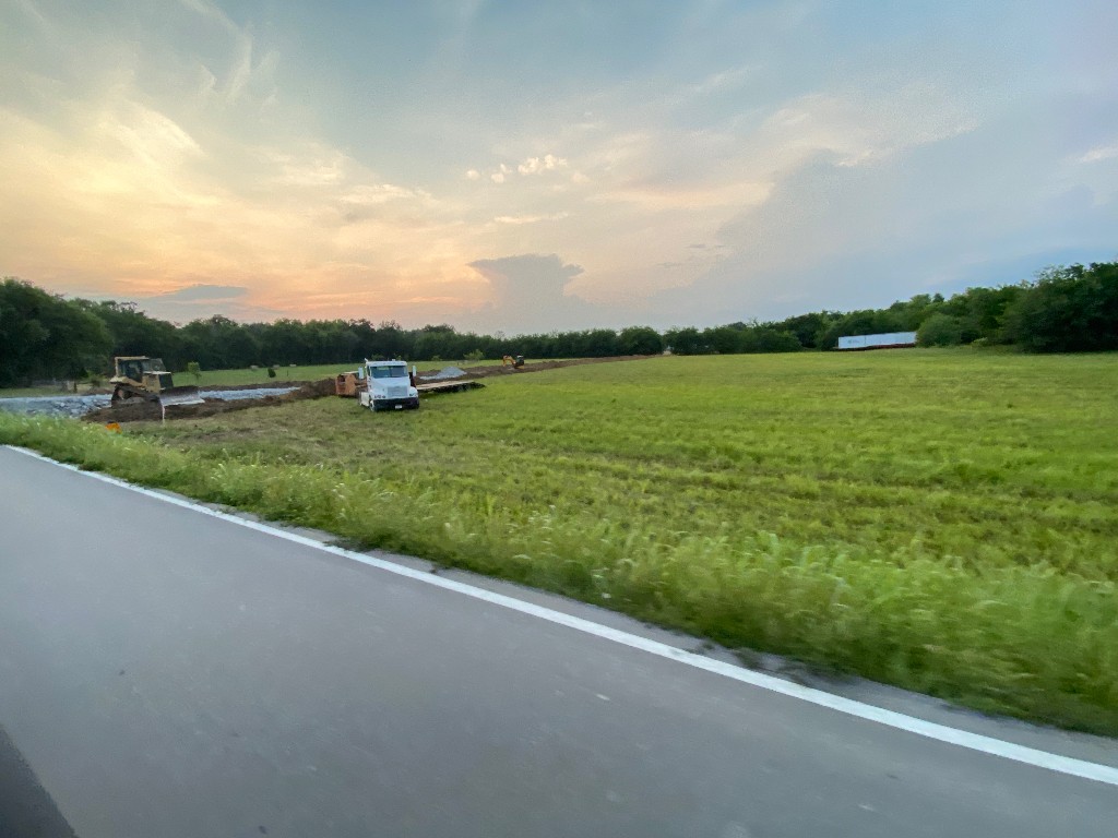 a view of a field with a lake