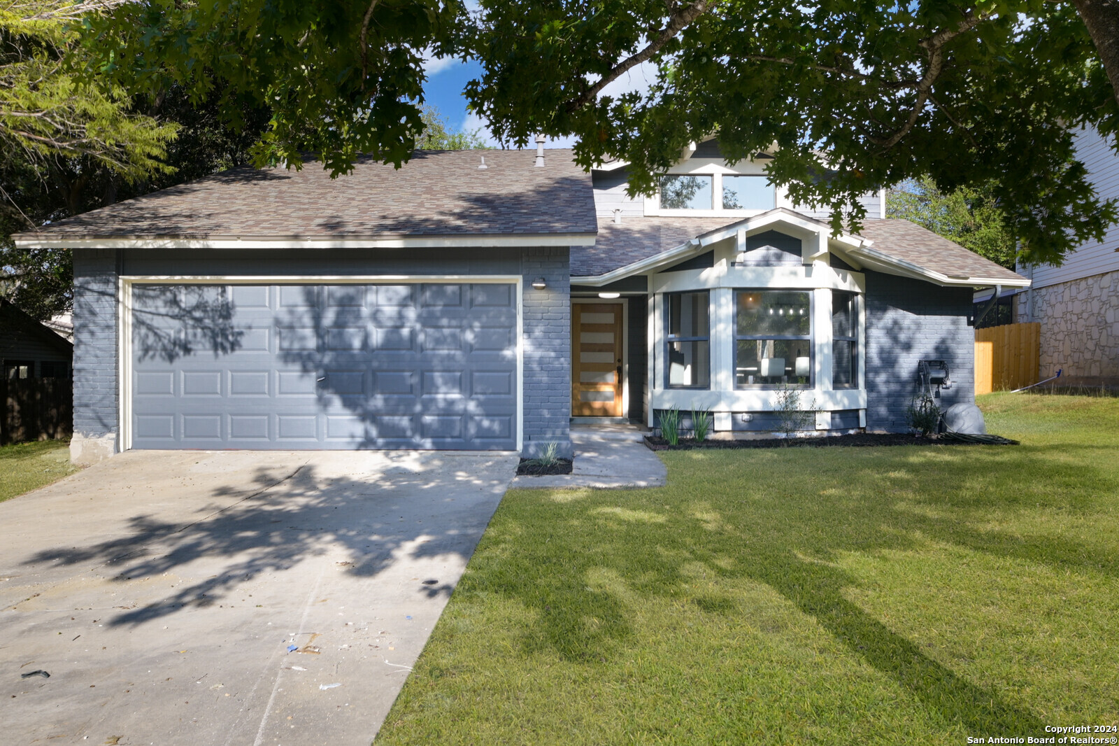 a front view of a house with a yard garden