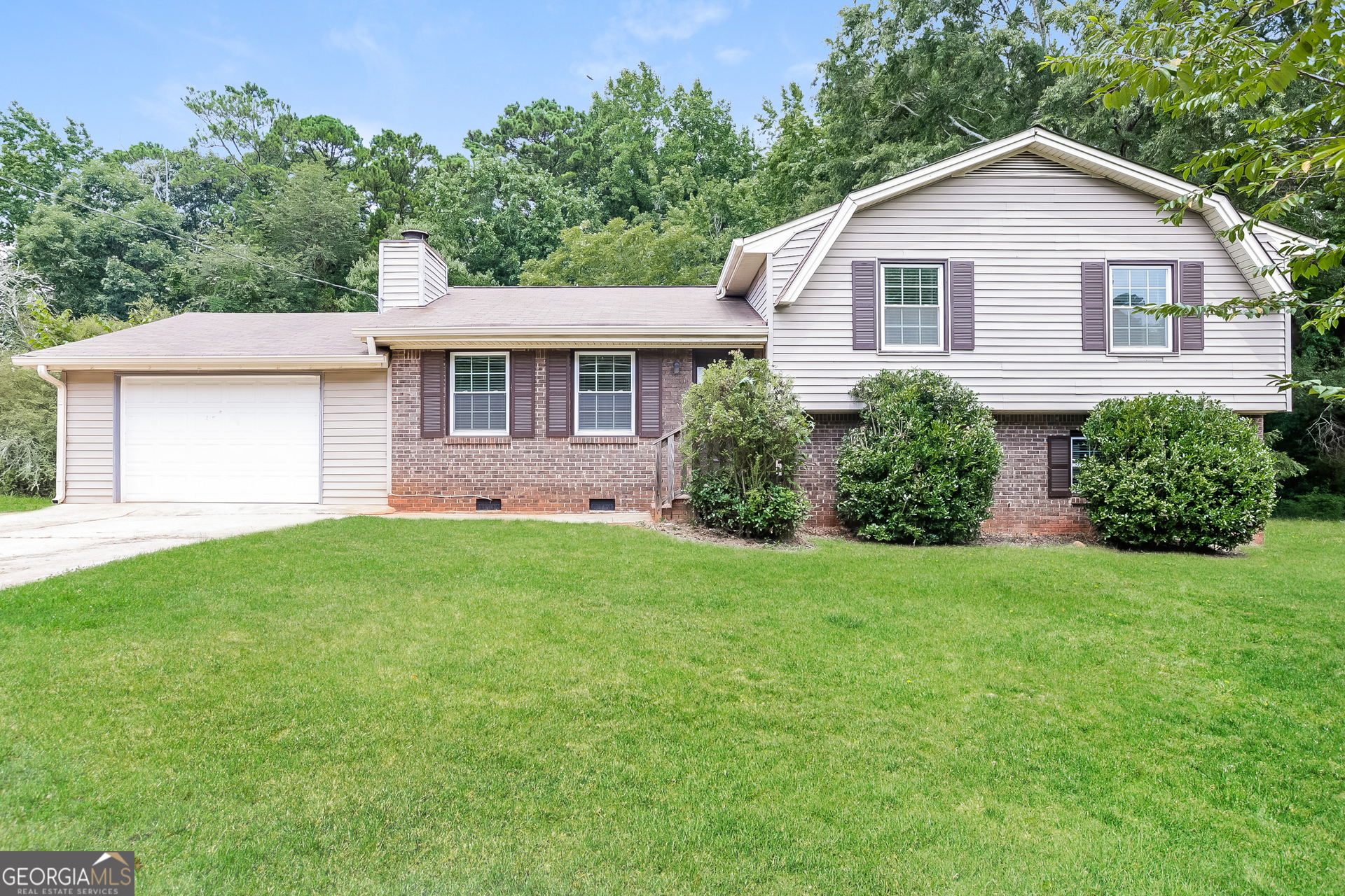 a view of a house with yard and a garden