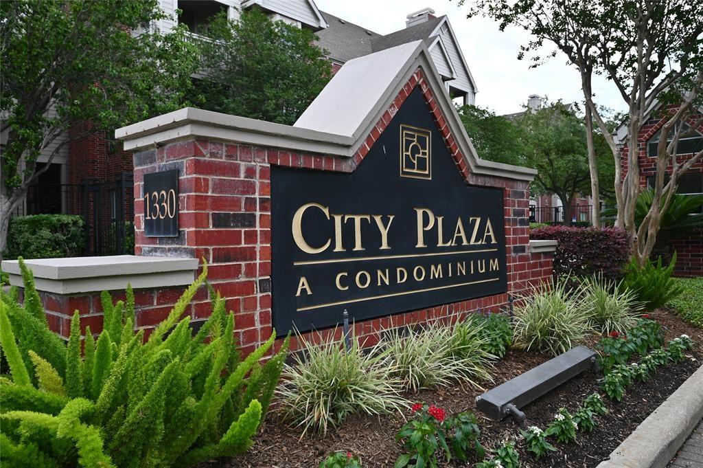 a view of sign board with flower plants