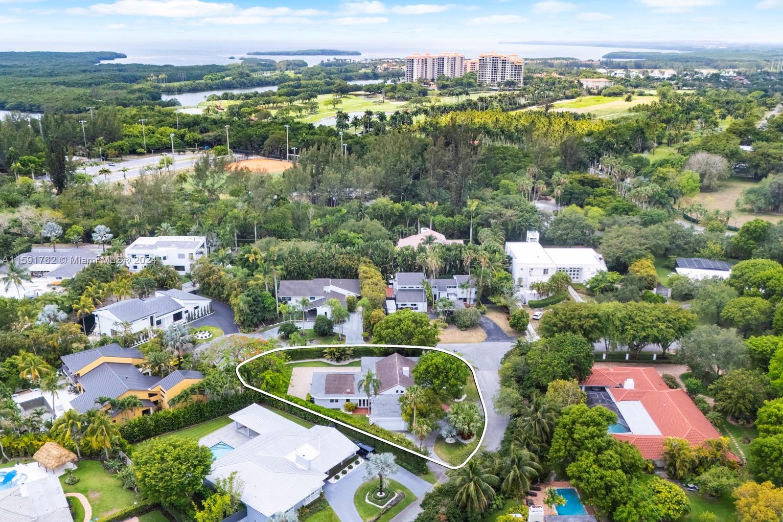 an aerial view of residential houses with outdoor space and river