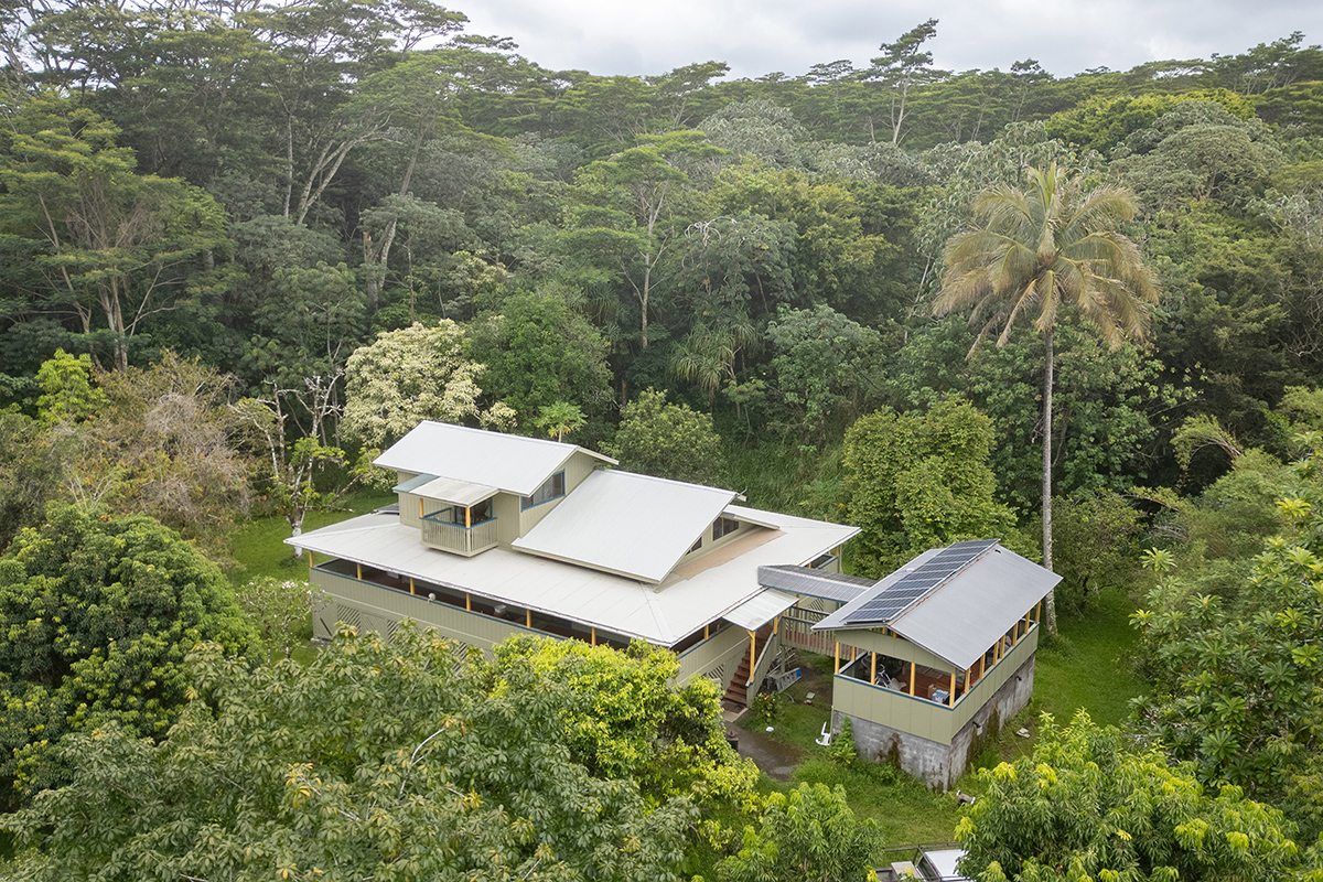 an aerial view of a house with a yard