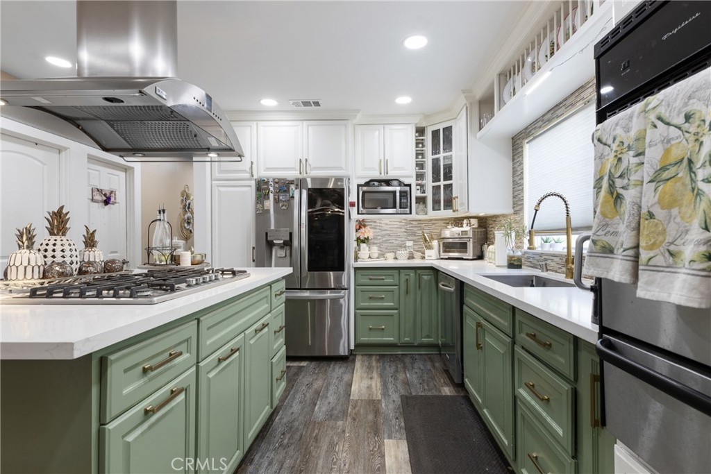 a kitchen with lots of counter top space sink and stainless steel appliances