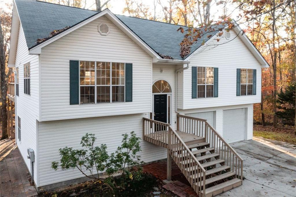 a front view of a house with a yard garage and outdoor seating