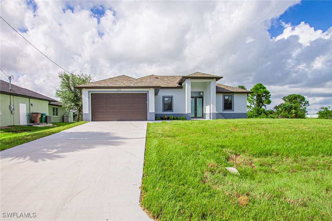 a front view of house with yard and green space