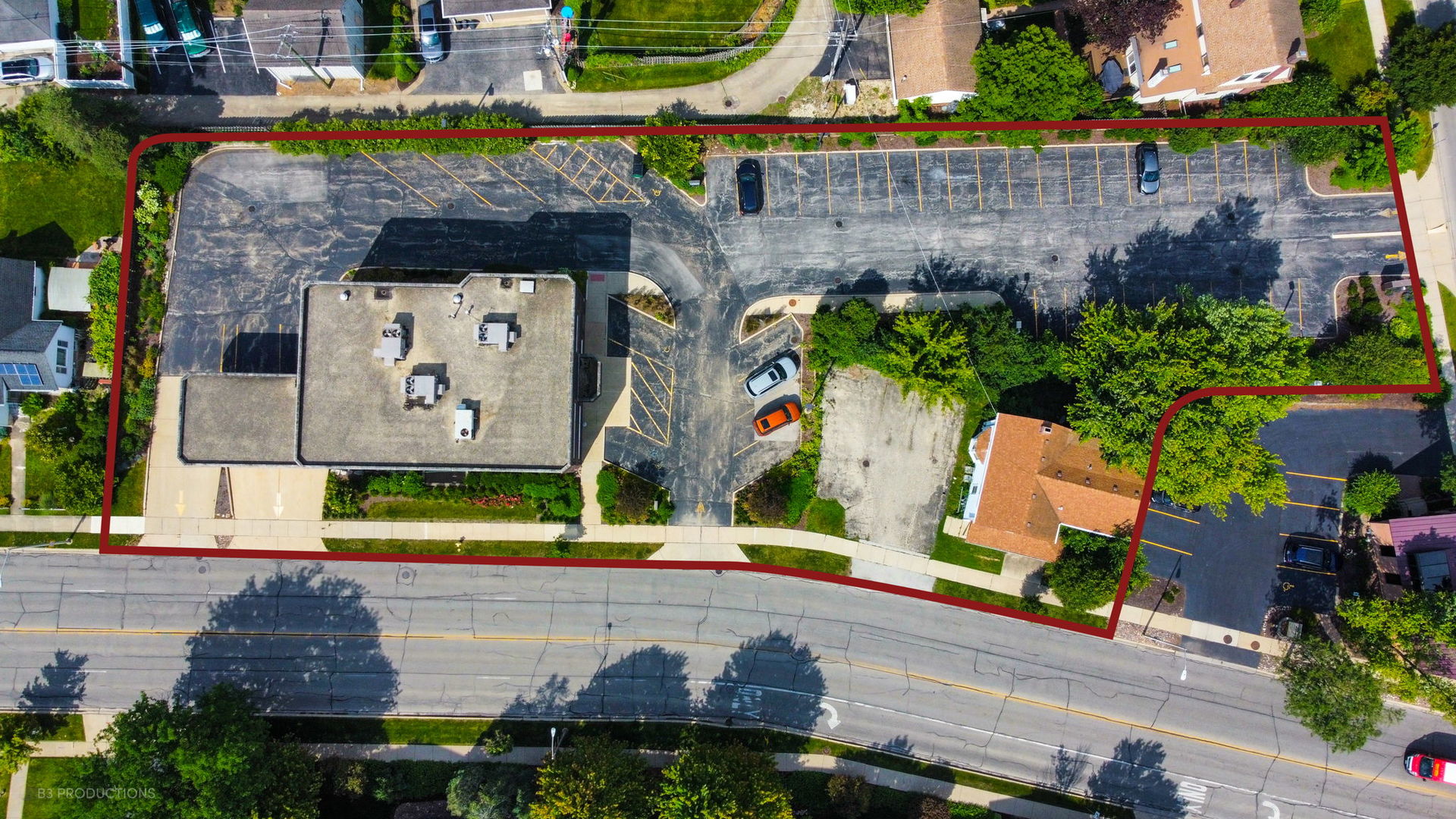 an aerial view of a house with a yard and a fountain