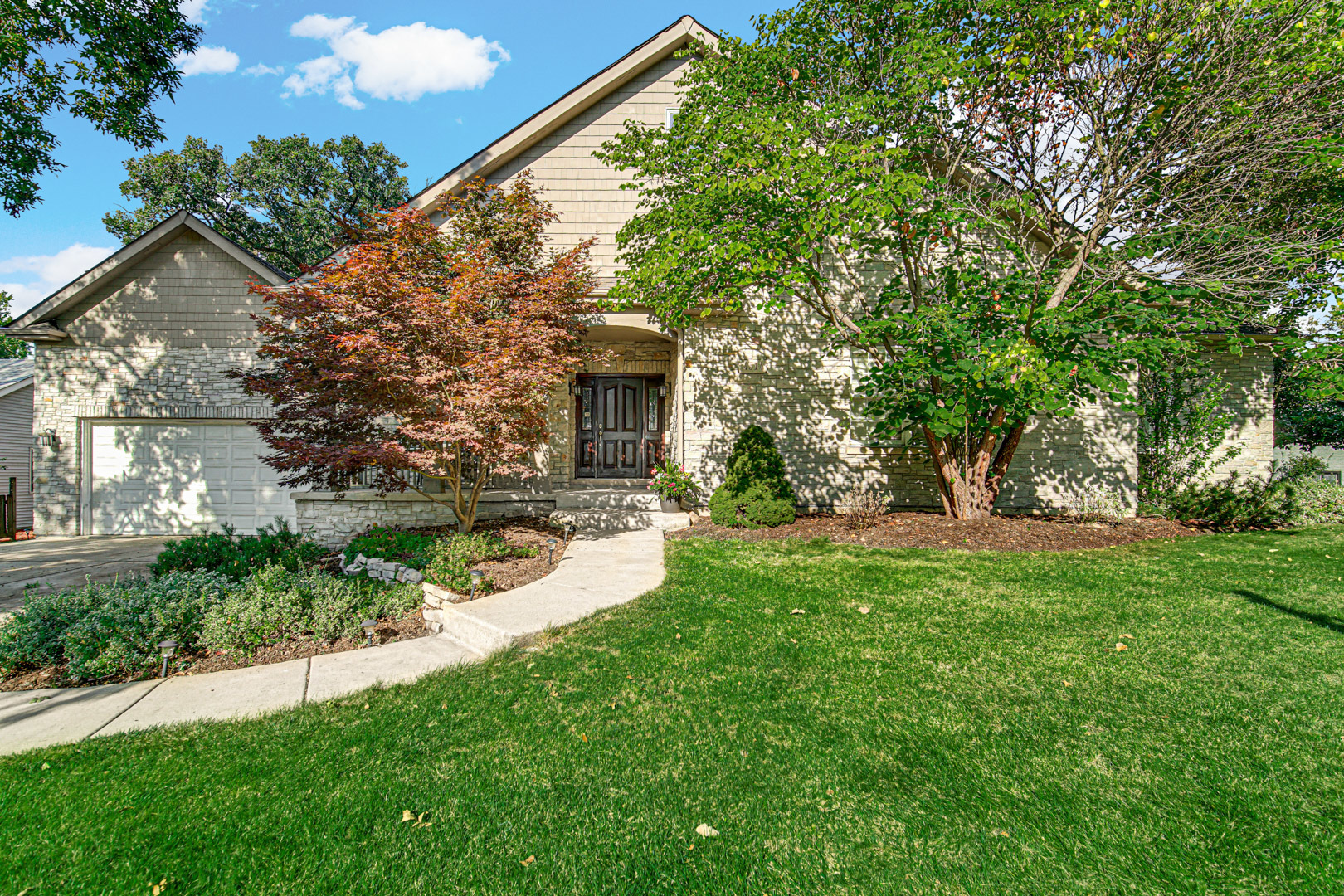 a view of a house with a backyard and a tree