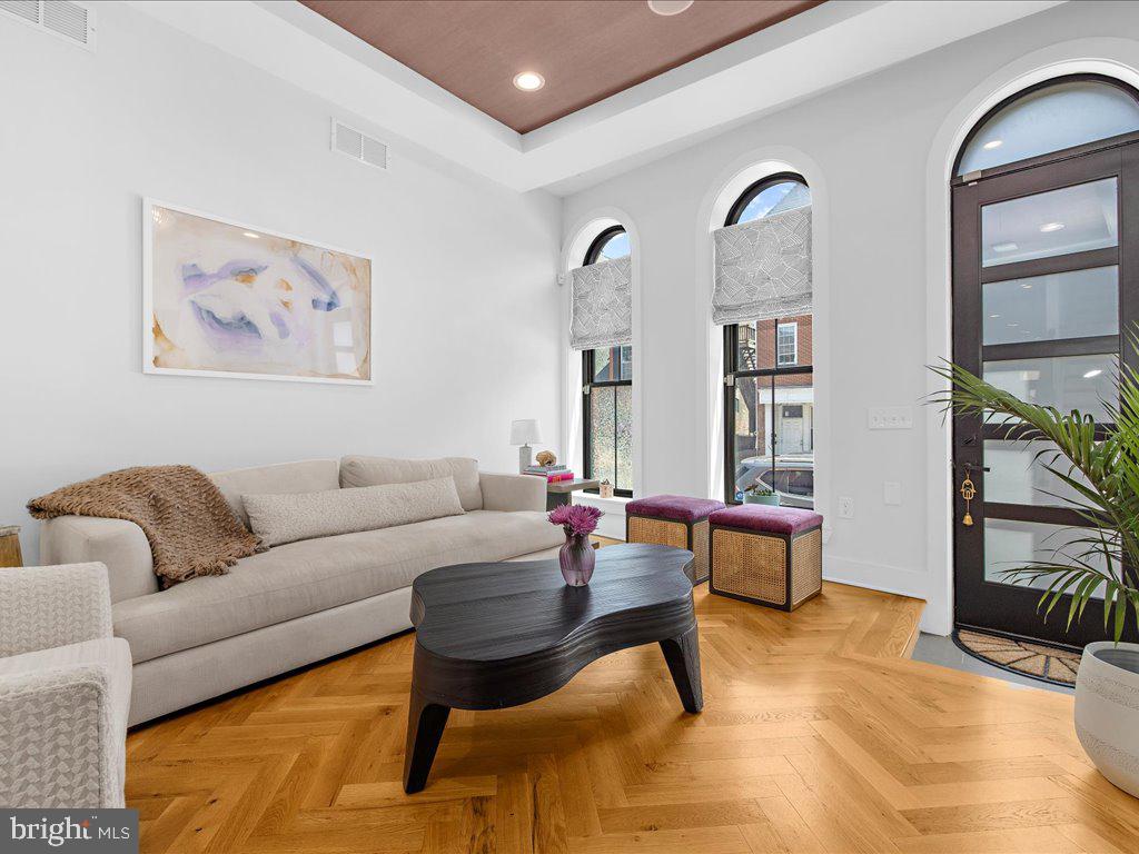 a living room with furniture and wooden floor