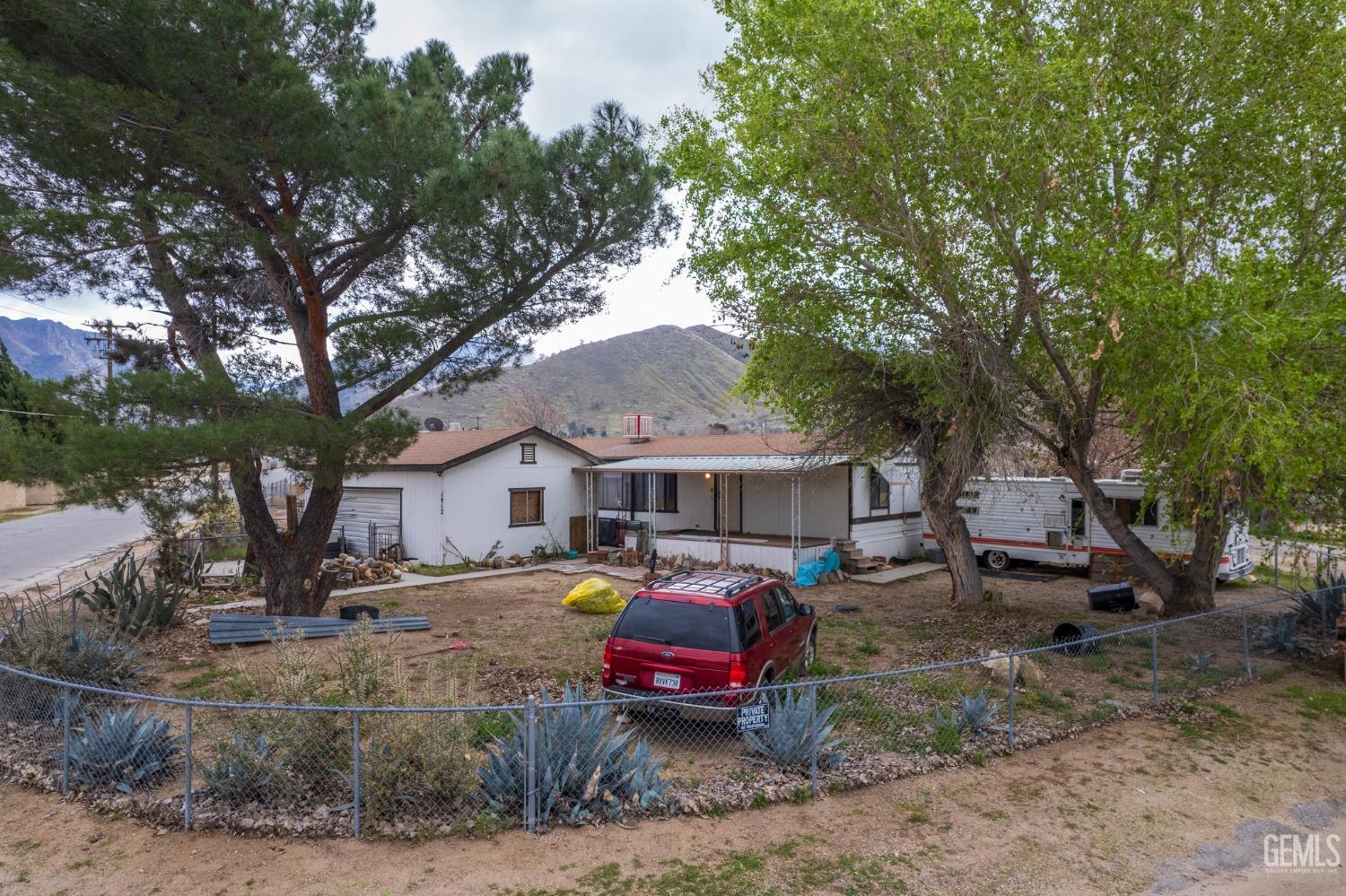 a front view of a house with cars parked