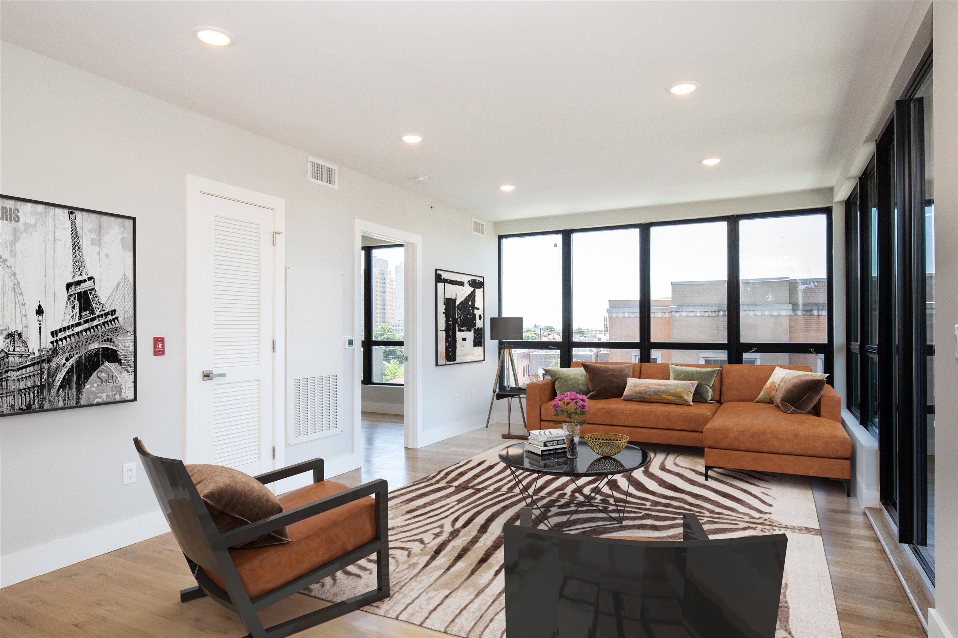 a bedroom with furniture and a large window