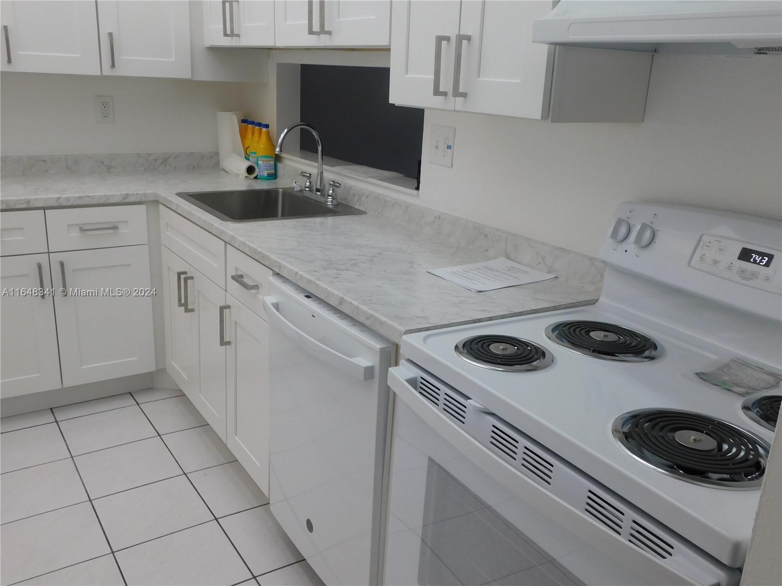 a kitchen with a stove and a sink