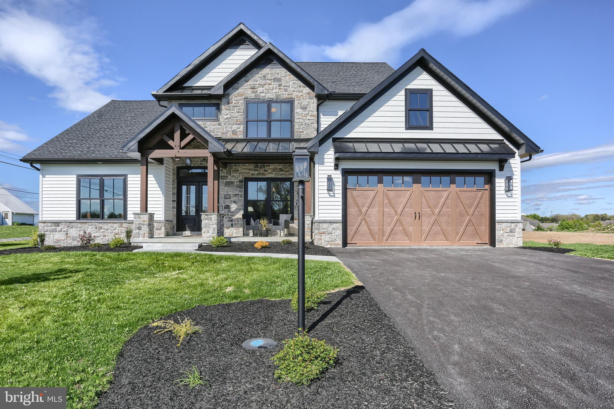 a front view of a house with a yard and porch