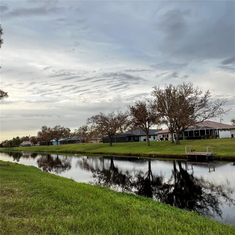 a view of a lake with houses in the back