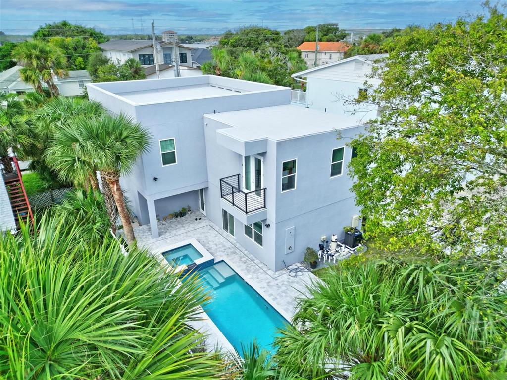 an aerial view of a house with deck and garden