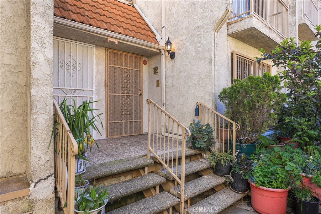 a view of balcony with furniture and flowers