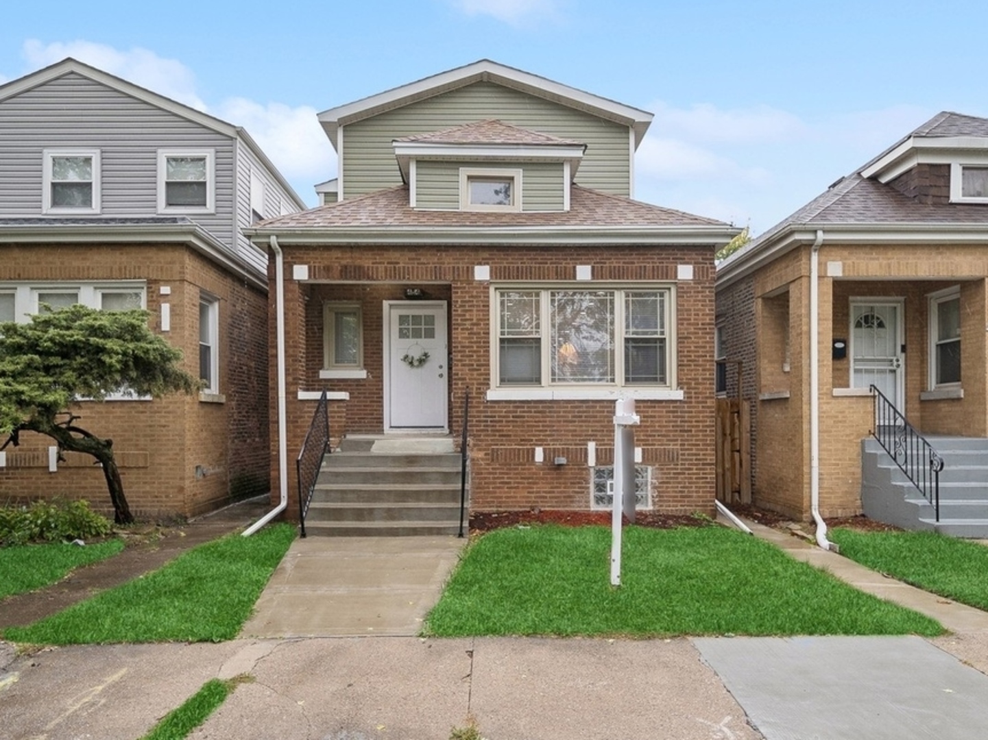 a front view of a house with a yard