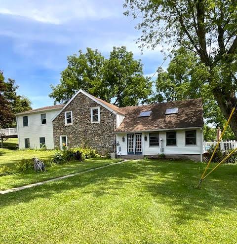 a front view of house with yard and green space