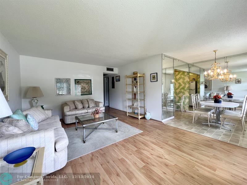 a living room with furniture a rug and white walls