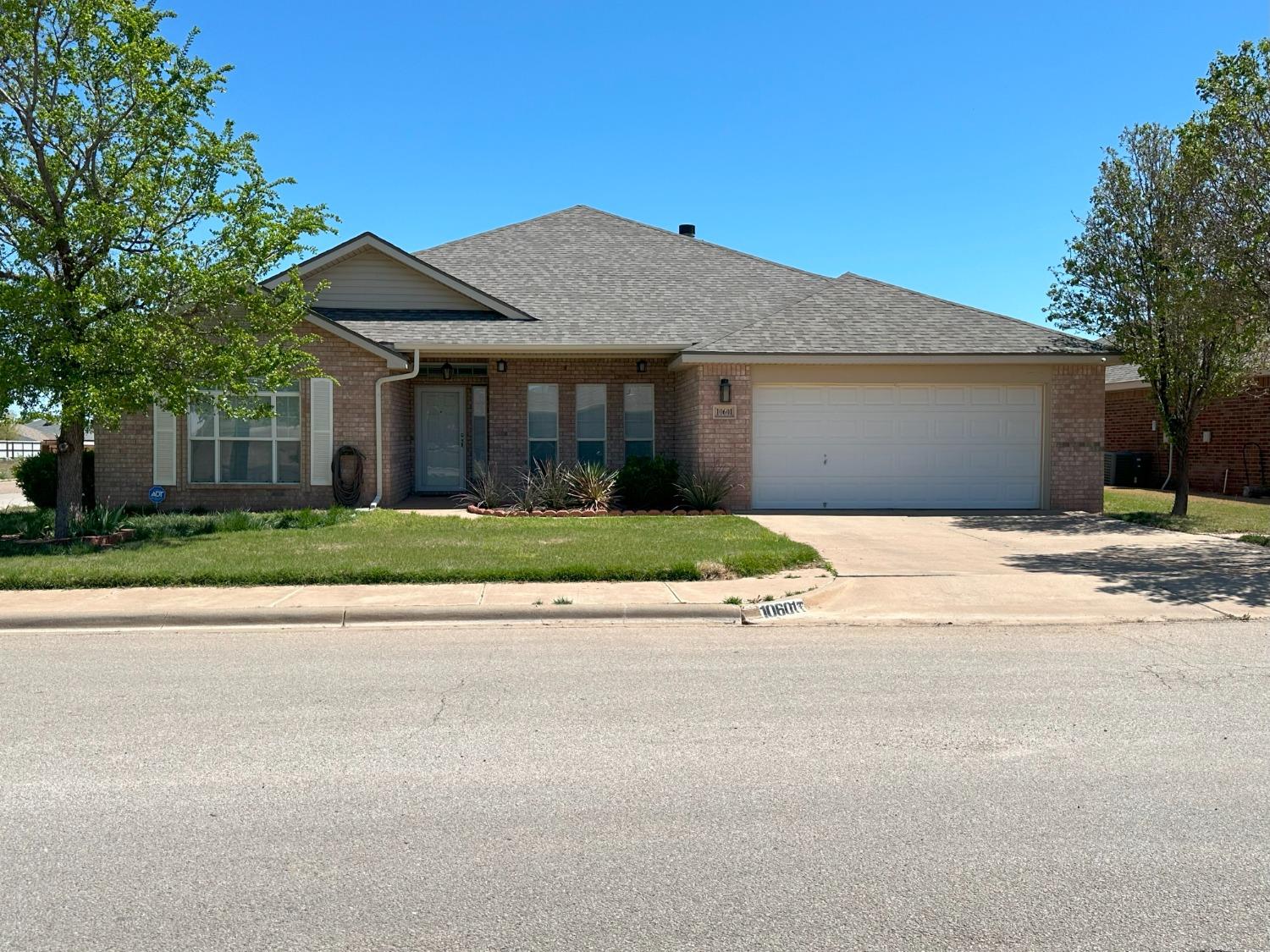 front view of a house next to a yard