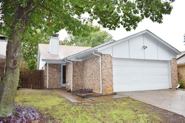 a view of a house with a garage and yard