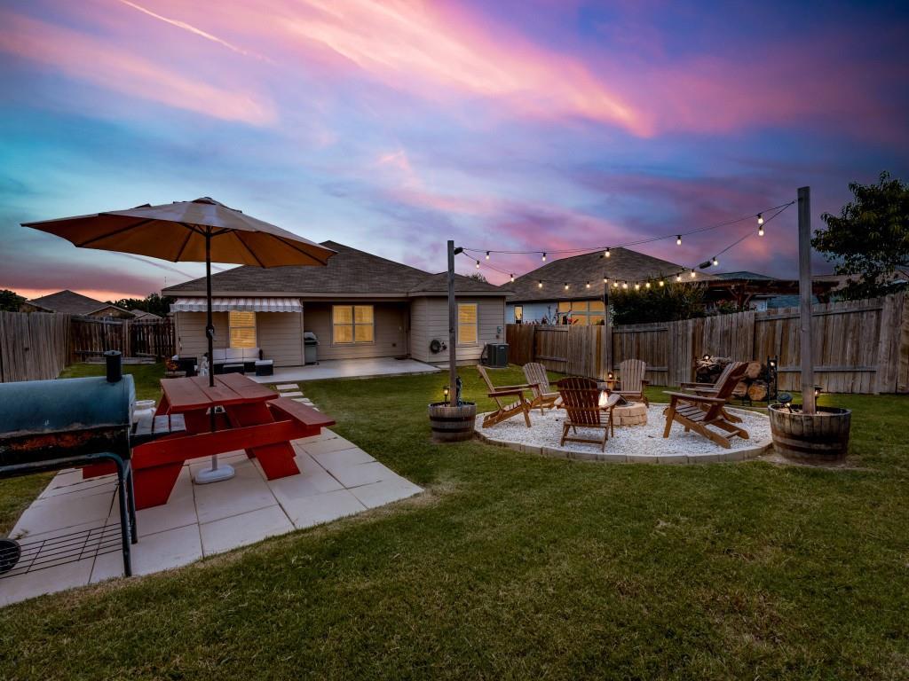 a view of a yard with furniture and outdoor seating