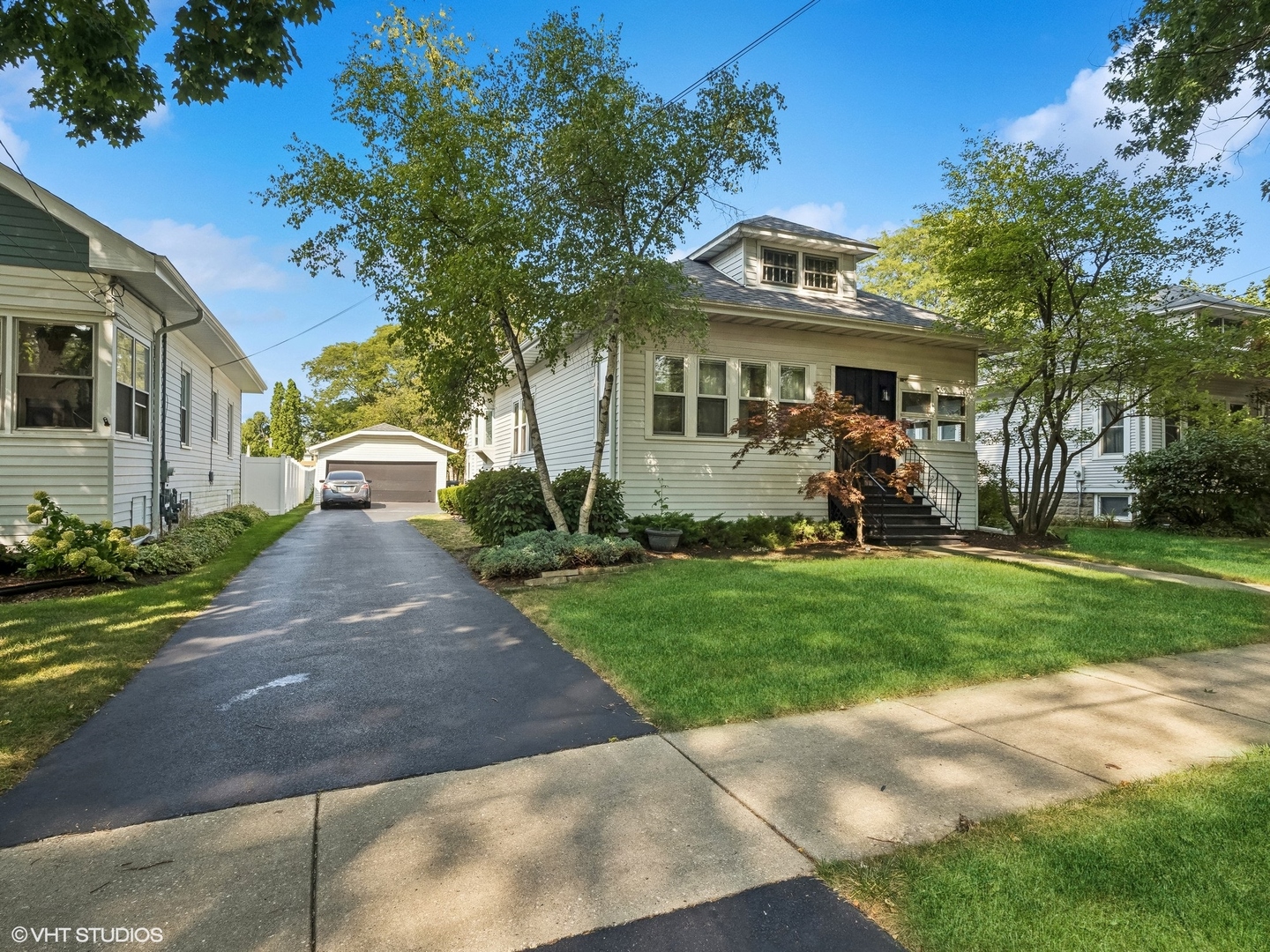 a front view of house with yard and green space