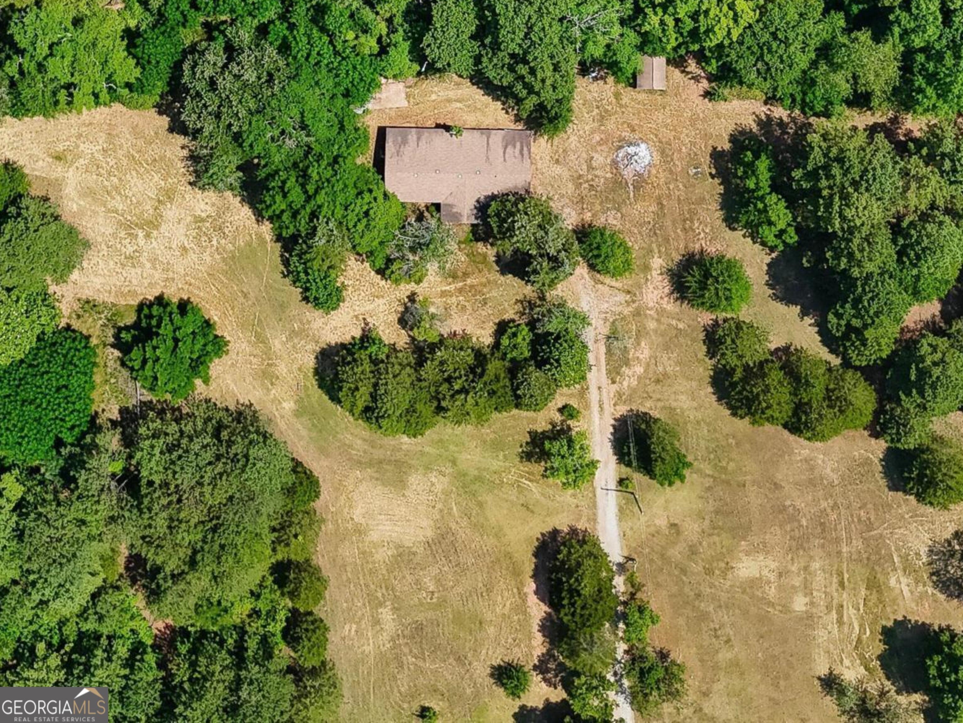 an aerial view of a house with a yard