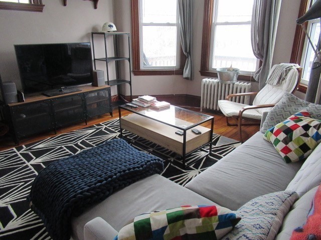 a living room with furniture and a flat screen tv