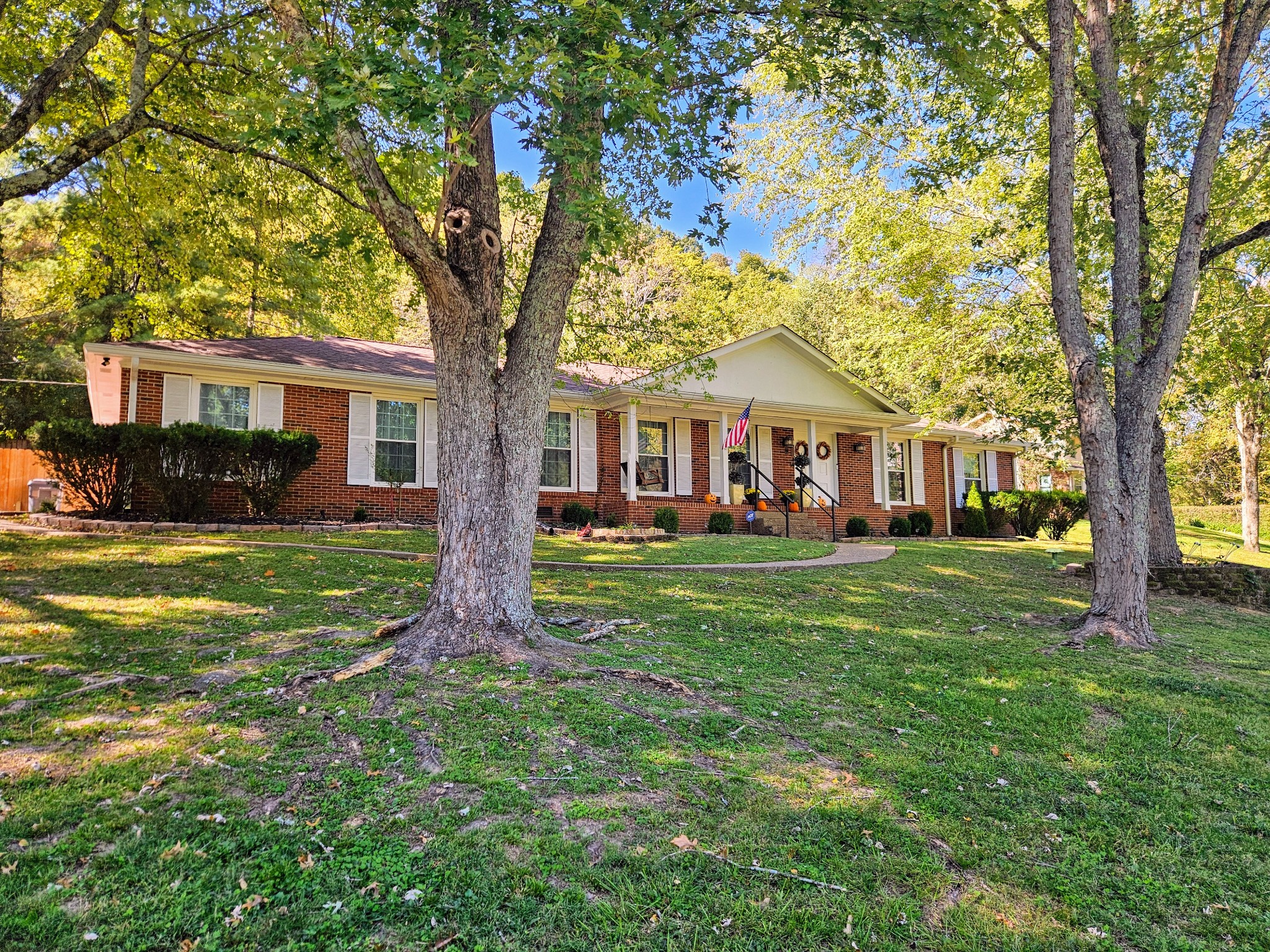 a front view of house with yard and green space