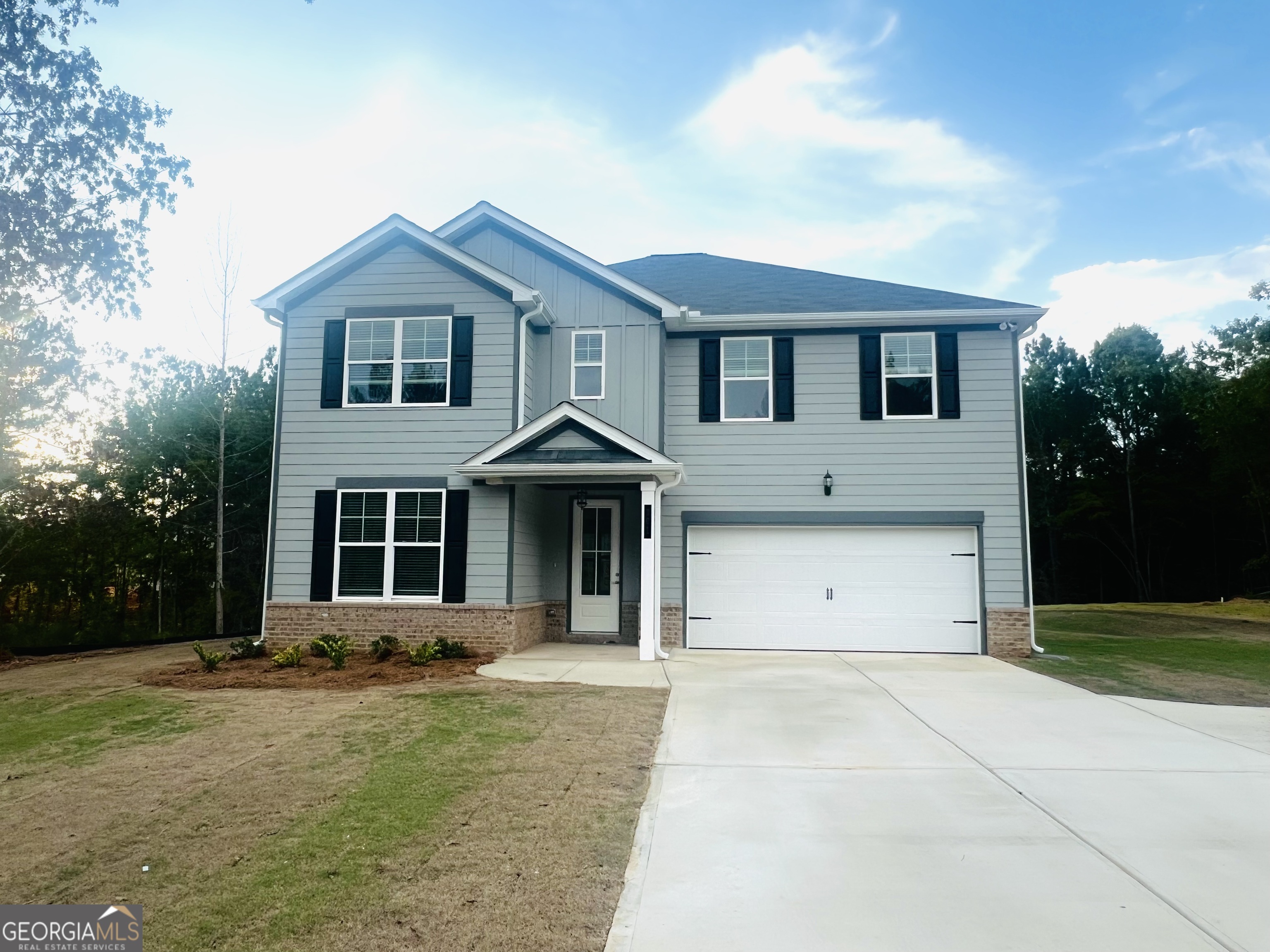 a front view of a house with a yard