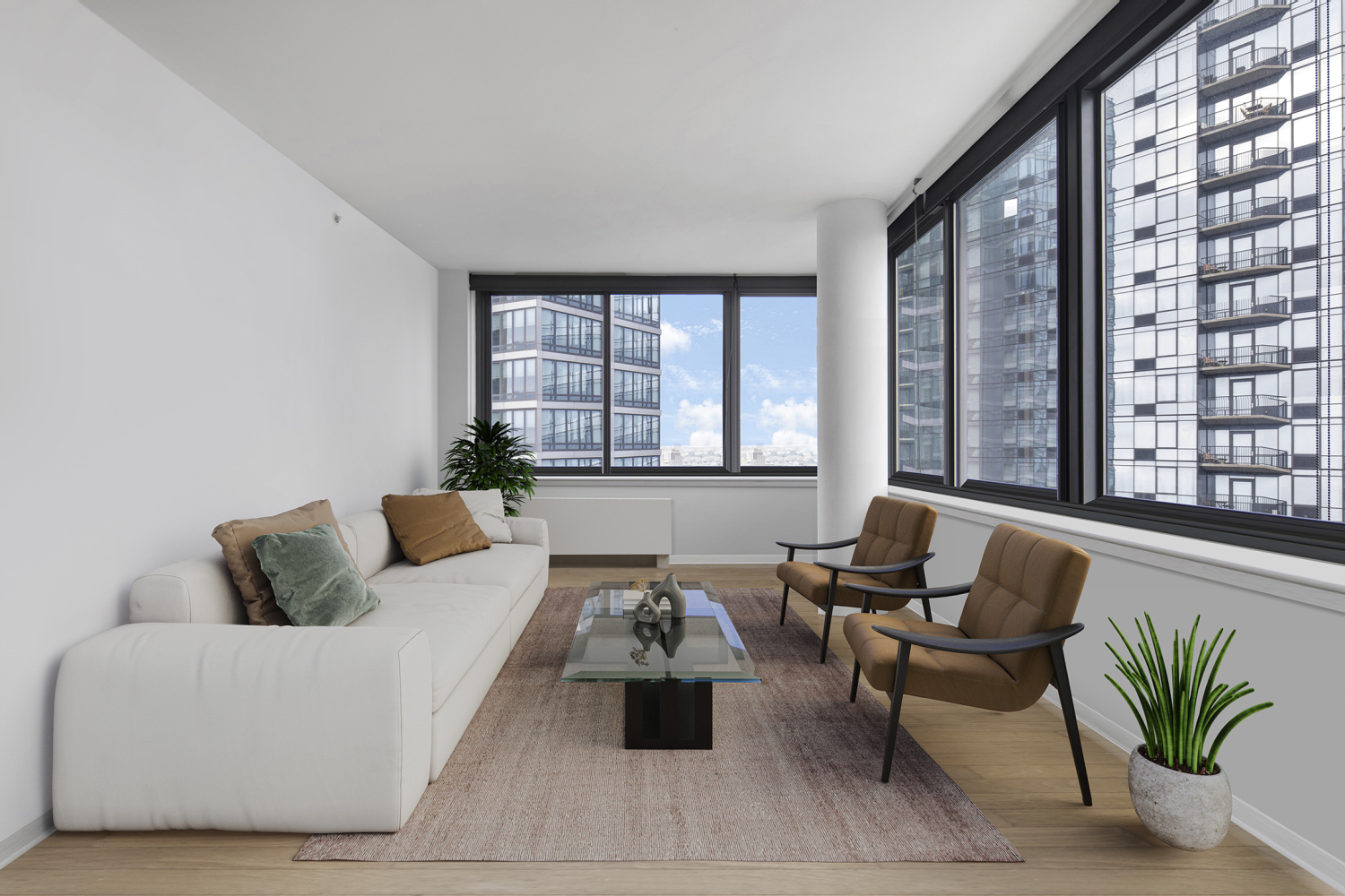 a living room with furniture and floor to ceiling windows