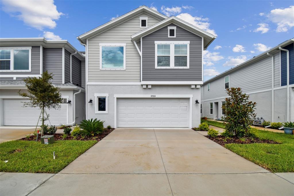 a front view of a house with a yard and garage