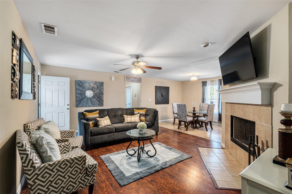 a living room with furniture fireplace and flat screen tv