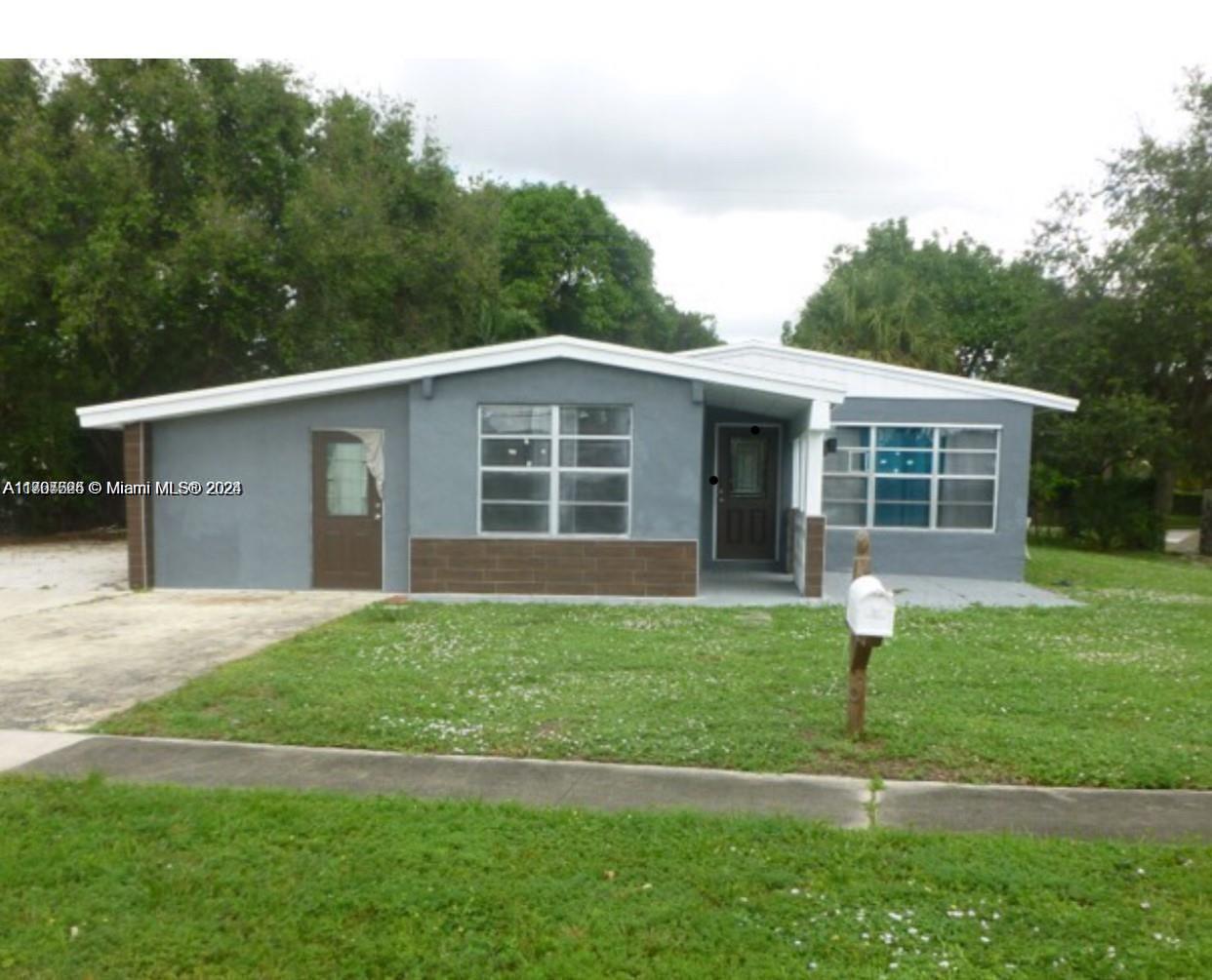 a front view of a house with a yard and porch