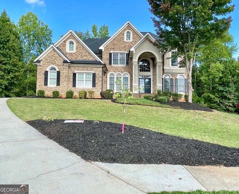 a front view of a house with a yard