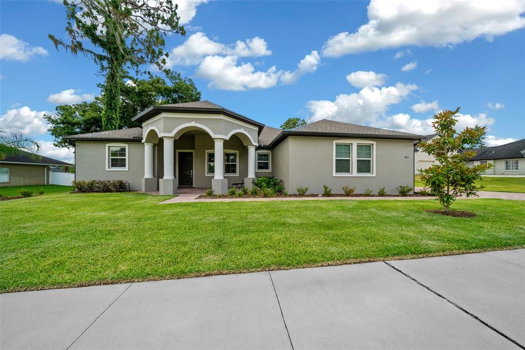 a front view of house with yard and green space