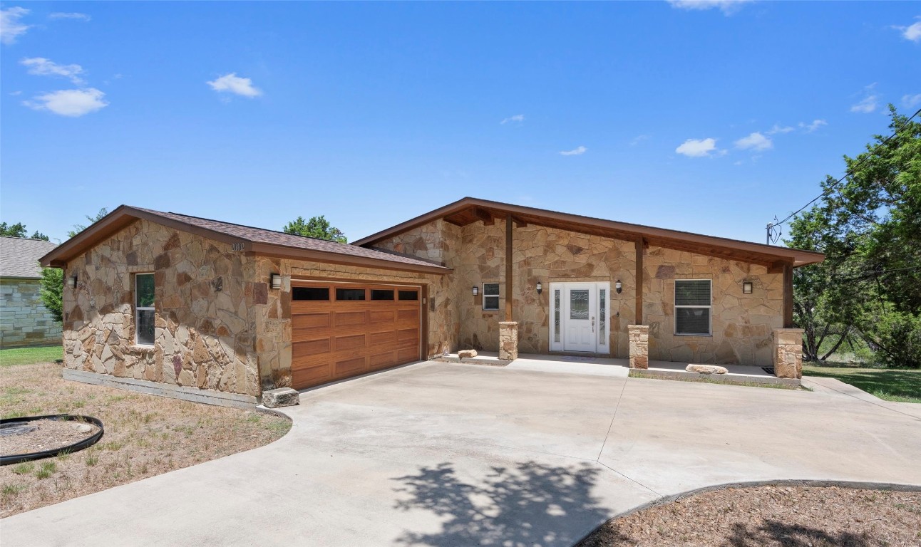 a front view of a house with yard and garage