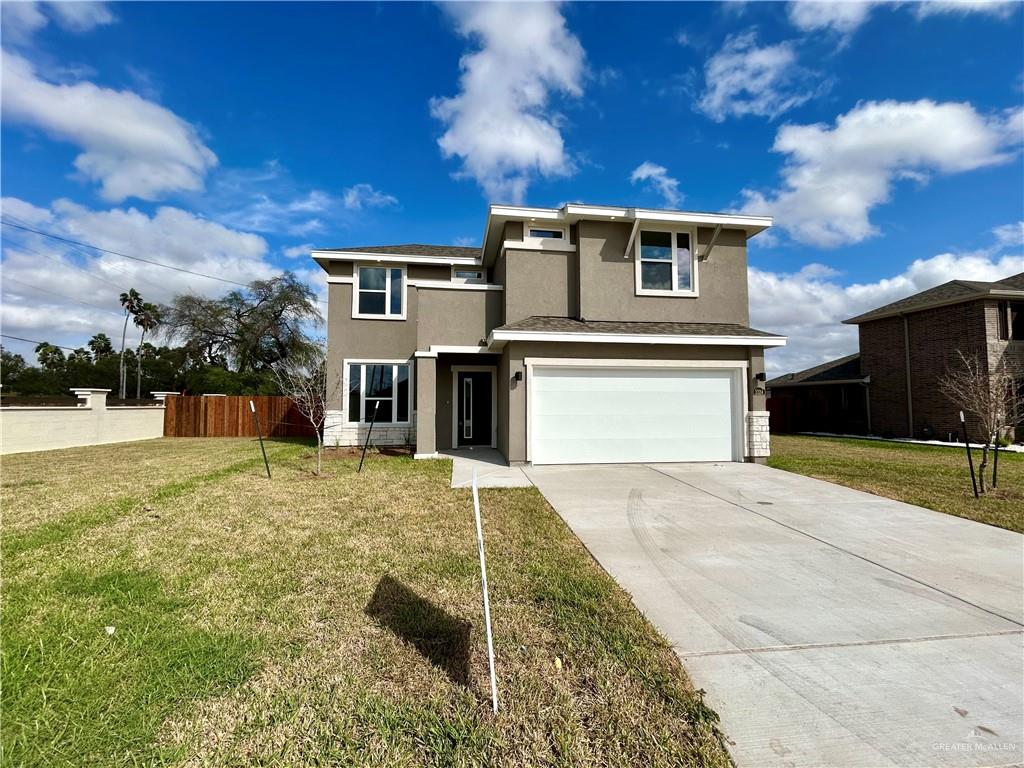 Front facade with a garage and a front lawn