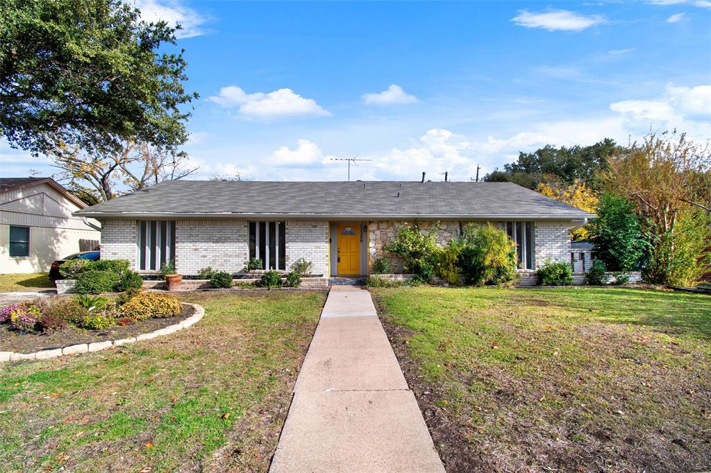 One story Ranch-style brick home with large front yard.