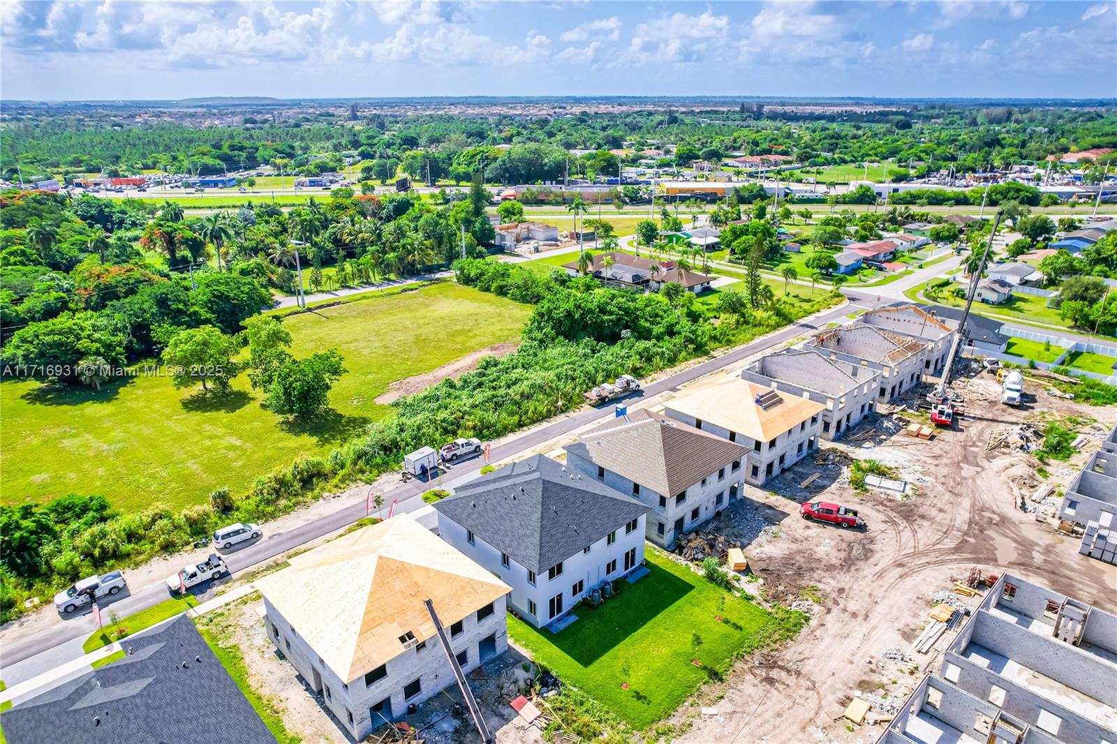 an aerial view of a house with a garden and lake view