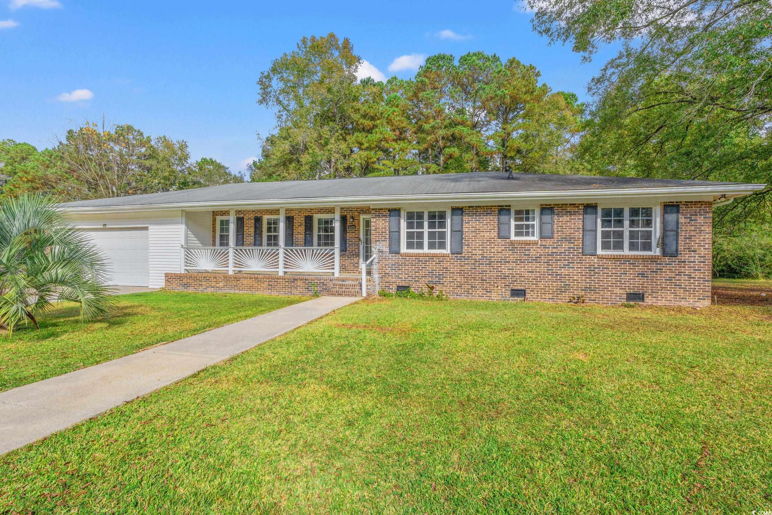 Ranch-style house with a garage, a front yard, and