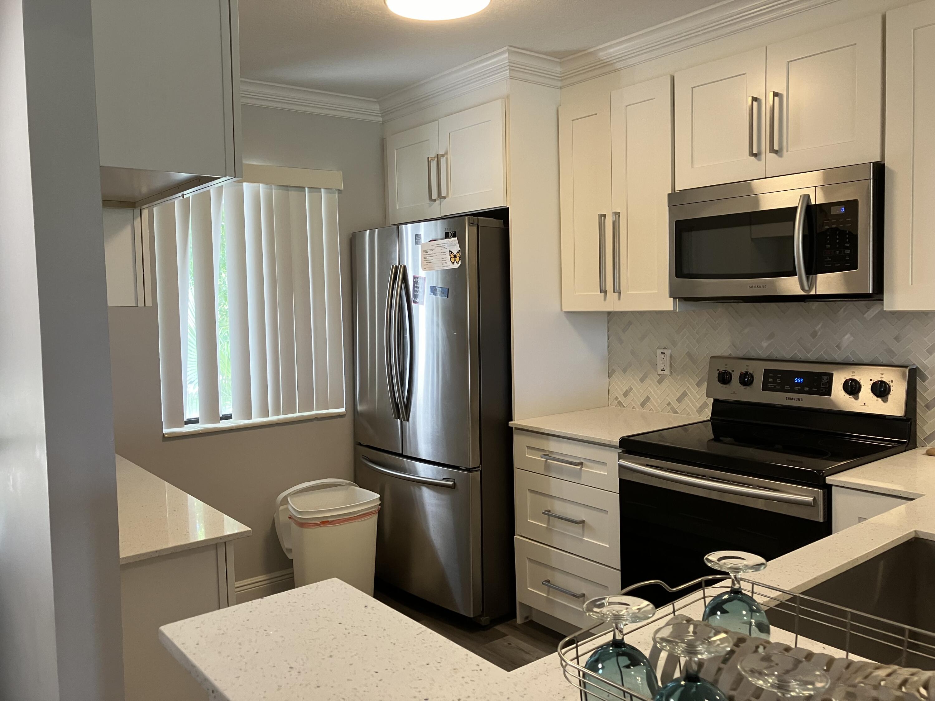 a kitchen with stainless steel appliances a refrigerator stove and microwave