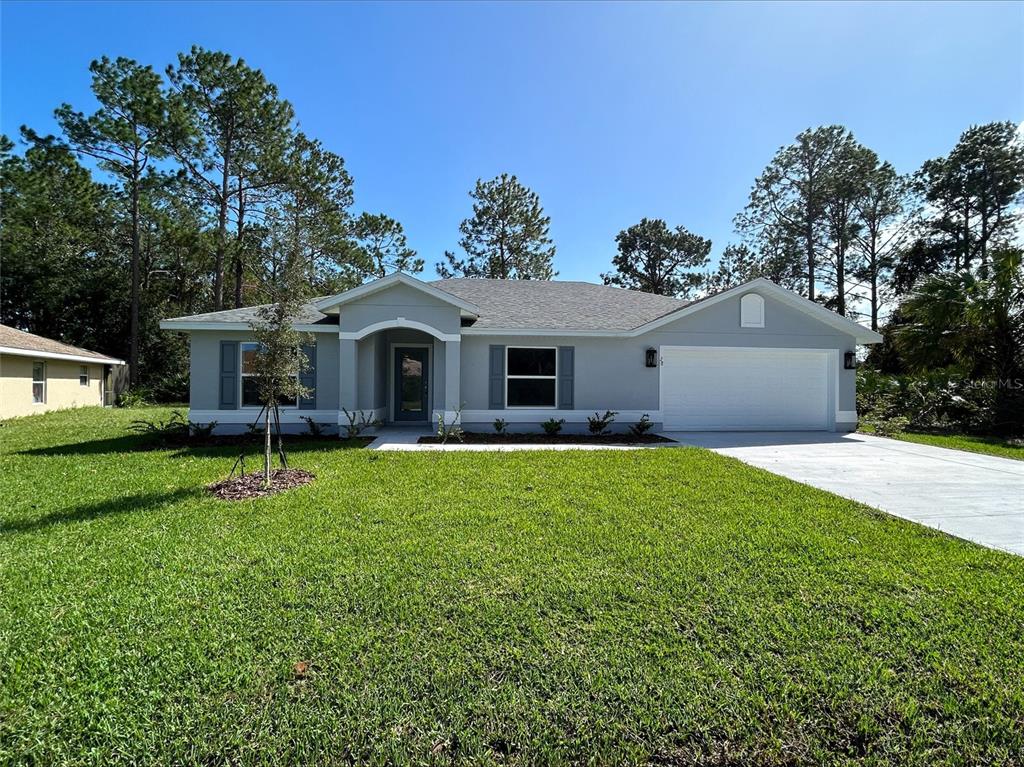 a front view of a house with a garden and yard