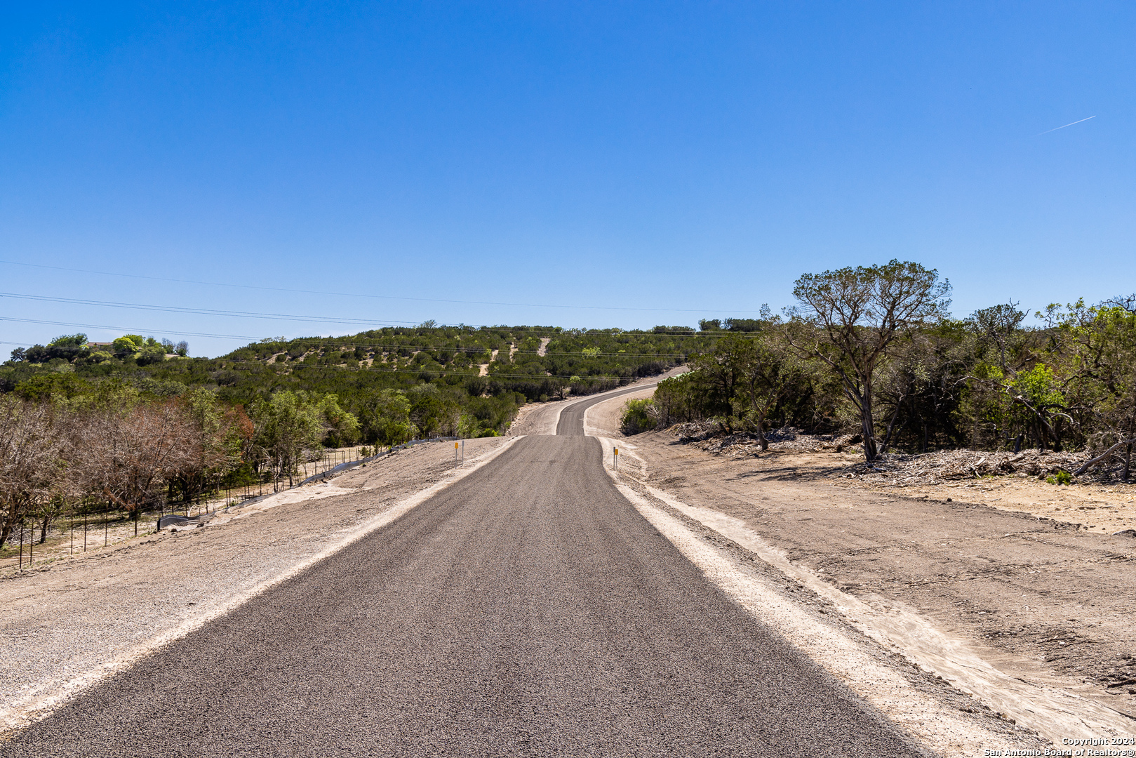 a view of a road with a building in the background