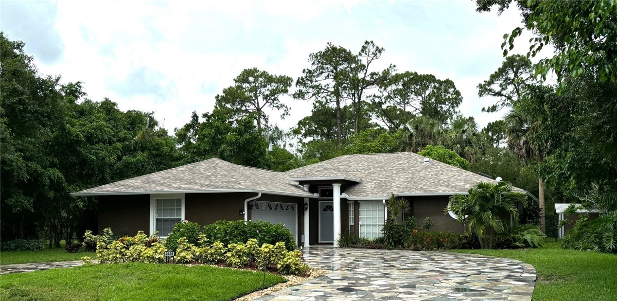 a front view of a house with garden